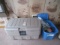 Rubbermaid tote with clothing, mower parts
