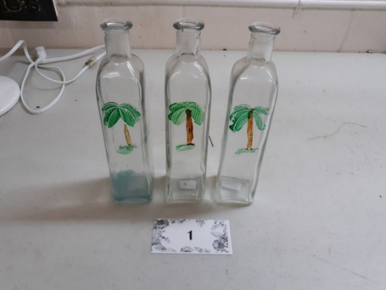 three bottles for oil, embossed and painted palm trees