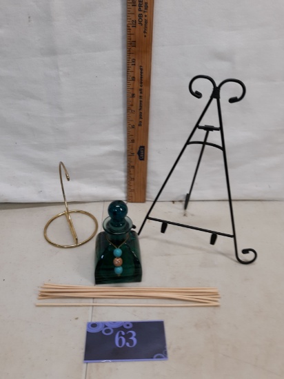green glass bottle with stopper, plate easel