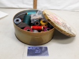 tin of various spools of thread