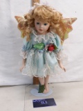porcelain doll with wings on stand