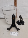 trashcan in holder with metal bookends and plate easel