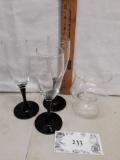 brandy sniffer glass and three black stem champagne flutes