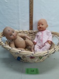 woven large basket with two plastic head/hands/feet dolls
