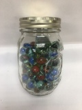 Small Jar Full of Marble and a Shooter