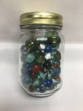 Small Jar Full of Marble and a Shooter