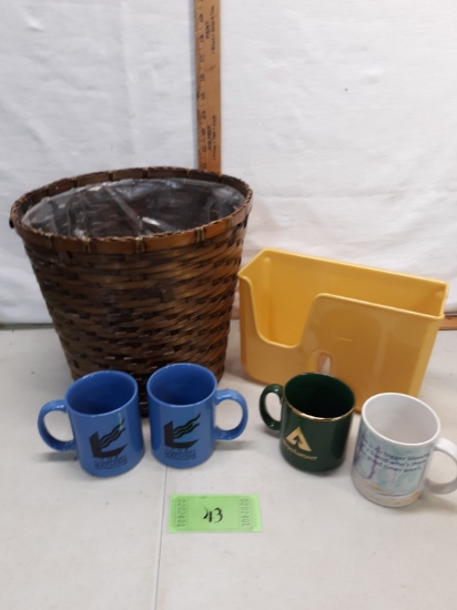 plastic lined woven trash basket, mugs, gold plastic organizer thing