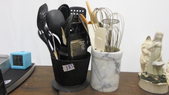 kitchen tools, two containers full of serving spoons, spatulas,wisk and more