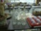 bottle lights and decanter, two wine bottles with grape vine pattern and lights inside them and a cl