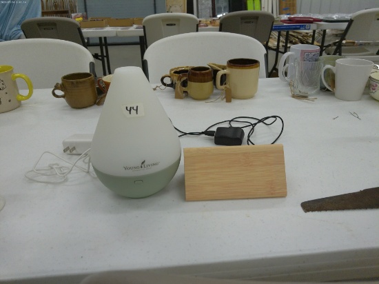 home electronics, digital modern wood alarm clock and a young living essential oils machine both in