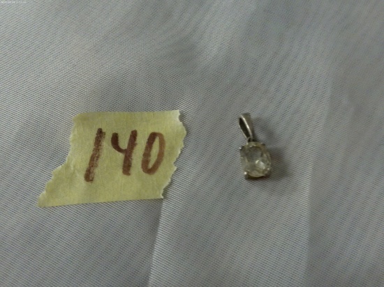 sterling charm, has a large clear stone