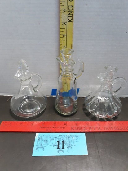 Three clear glass cruets