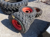 4 SKID STEER TIRES AND RIMS