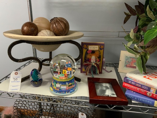 Everything on the shelf in pitcure, home decorative items, snow globe, books