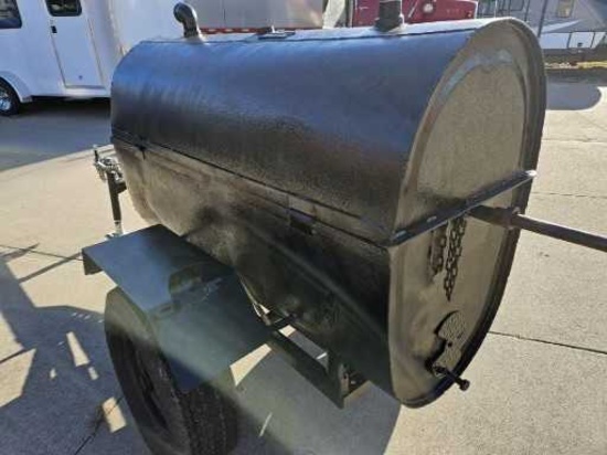 Hog cooker/smoker/grill with motorized rotisserie.