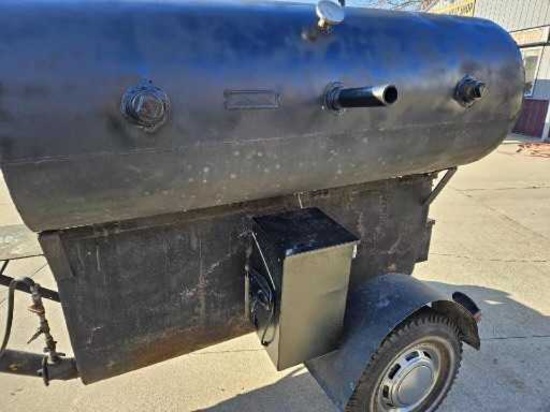 Hog cooker/smoker/grill with two built-in smoke boxes.