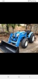 Tractor, bucket, forks, root rake, and scrape all together