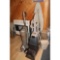 Two vaccuum cleaners, ironing board, trash can, and two irons