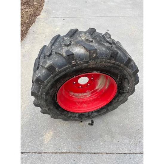 Skid Steer Tires. One New Tire and Rim and 4 Used Tires