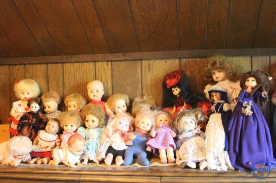 Baby dolls and porcelain dolls on dresser