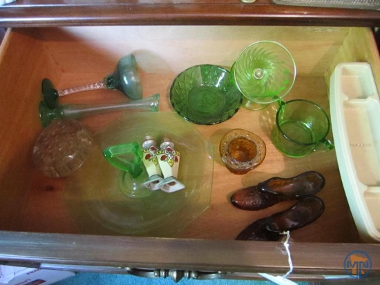 Green and pink colored glass, amber glass shoes, flower frog, and stoneware dishes