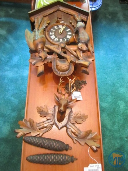 Cuckoo clock with sportsman theme