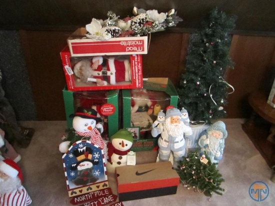 Christmas decorations: snowman sign, animated santas, lighted artificial tree, and mouse figurines
