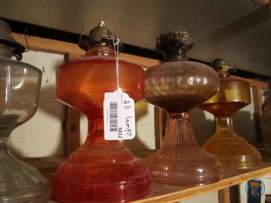 Clear and colored glass oil lamps with shades