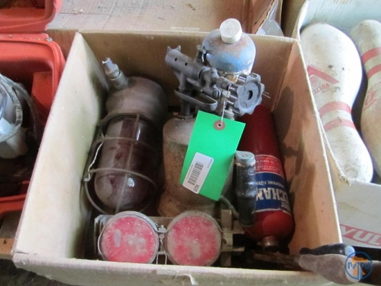 Soldering irons, gas torch, propane canisters, and enclosed light fixture with red shade