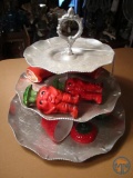 Tiered serving tray, vegetable salt and peppers, and covered strawberry dish