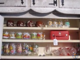 McDonalds glasses, Garfield mugs, Coca Cola glasses, and Hawaii coffee mugs