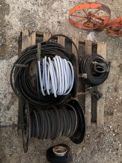 Pallet of pressure washer hoses and reels