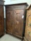 WOOD CABINET WITH CARVED PANEL DOORS