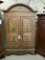 WOOD CABINET WITH CARVED PANEL DOORS