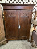 WOOD CABINET WITH CARVED PANEL DOORS
