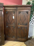 WOOD CABINET WITH CARVED PANEL DOORS