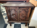 WOOD CABINET WITH CARVED PANEL DOORS