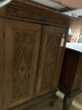 WOOD CABINET WITH CARVED PANEL DOORS