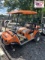 Orange Club Car Golf Car with Plum Quick Motor