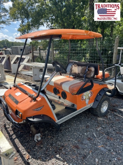 Orange Club Car Golf Car with Plum Quick Motor