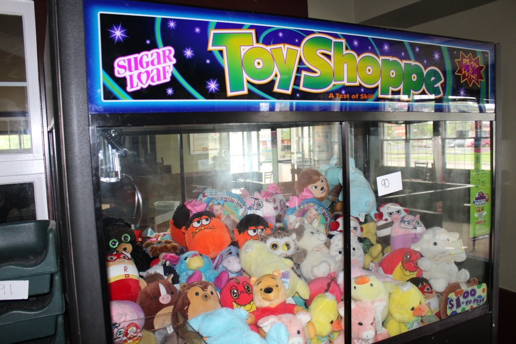 Sugar Loaf Toy Shoppe Claw Machine and contents Proxibid