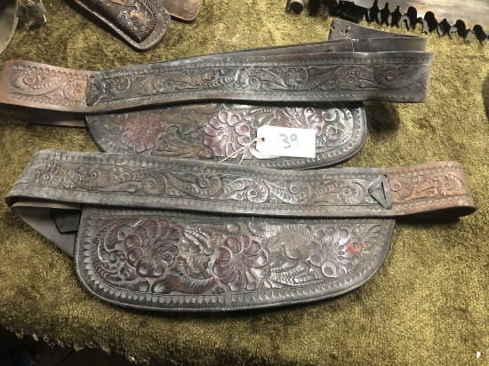 TWO CARVED LEATHER SADDLE PARTS