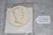 White ceramic plaque with profile of Abraham Lincoln