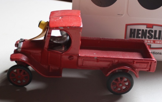 RED CAST IRON TRUCK WITH MAN, HAS PAINT CHIPS
