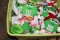 (2) Plastic totes of green stuffed M & M characters and plastic M & M chara