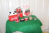 Assorted Coca Cola pieces, straw and napkin holder, yoyo's, lunchbox, jewel