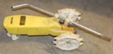 Yellow tractor shaped metal sprinkler