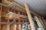 Lumber on north wall shelves, (3) 2x10, center, toward west