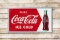 1950 Drink Coca-Cola w/ Bottle Metal Sign TAC 8.9