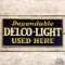 Dependable Delco Light Used Here Embossed SST Sign
